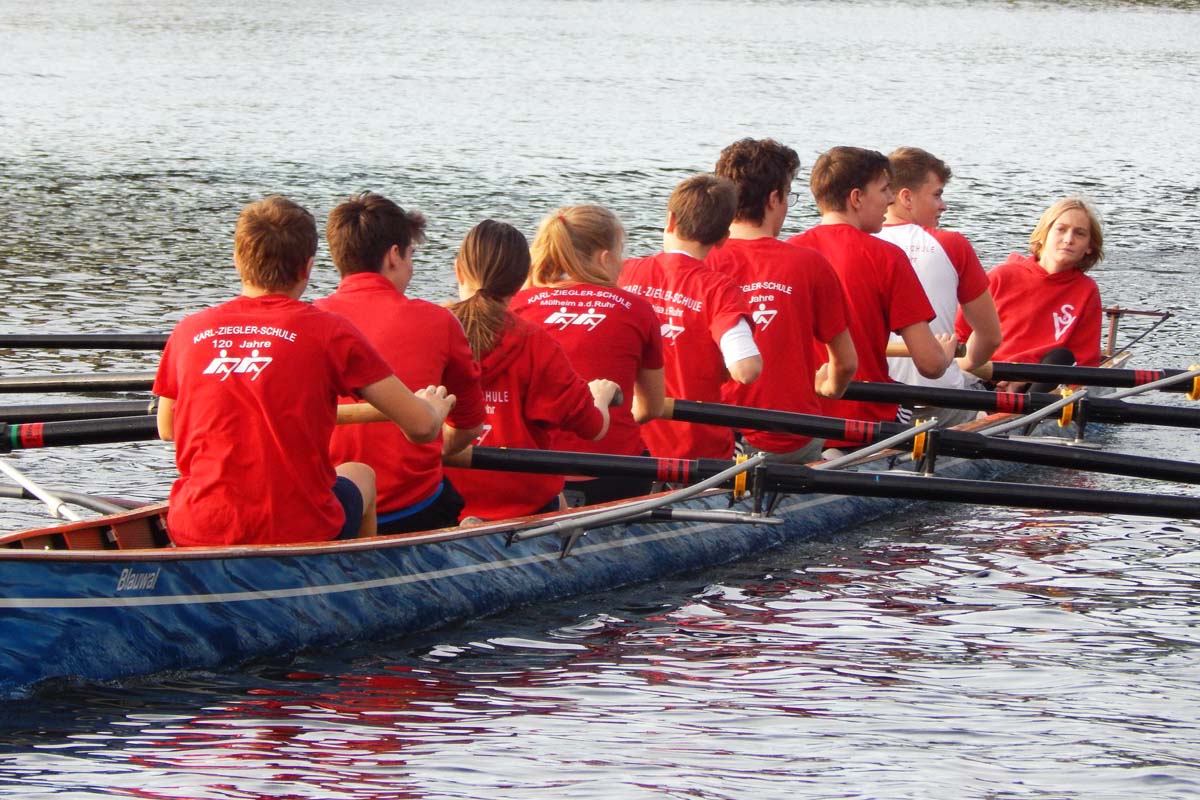 Schüler-Ruderteam der Karl-Ziegler-Schule im Achterboot auf dem Wasser.